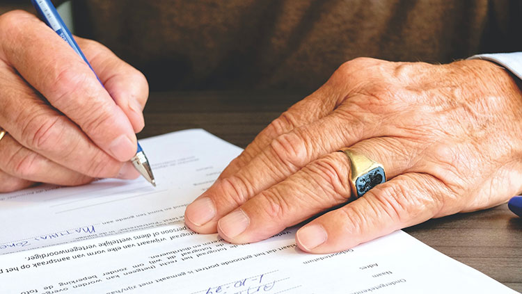 Picture of person signing a contract