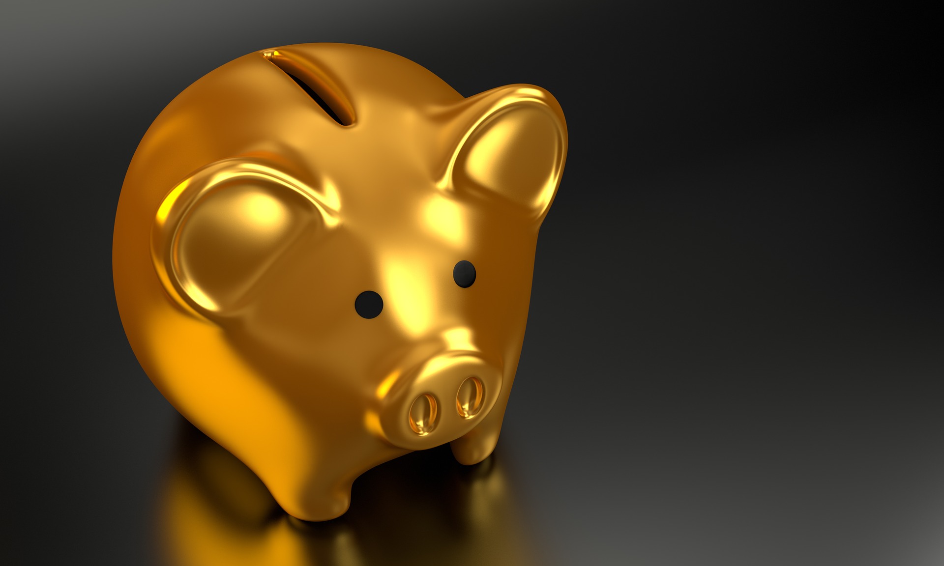 picture of gold piggy bank against black background