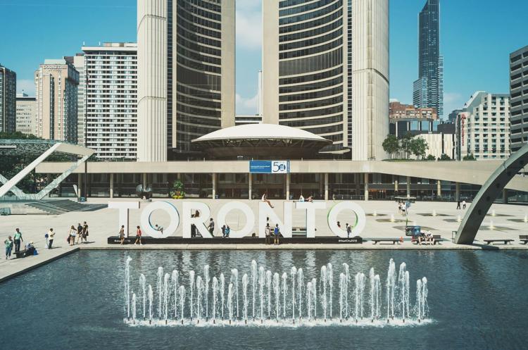 Picture of Toronto sign behind sprinklers