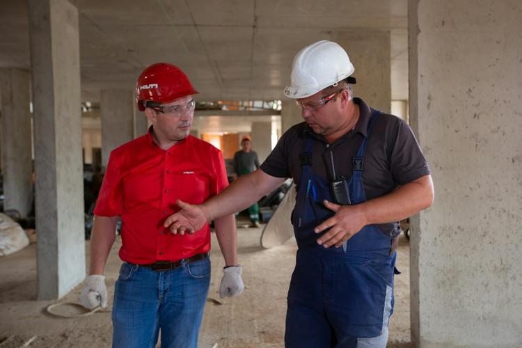 Two construction workers talking