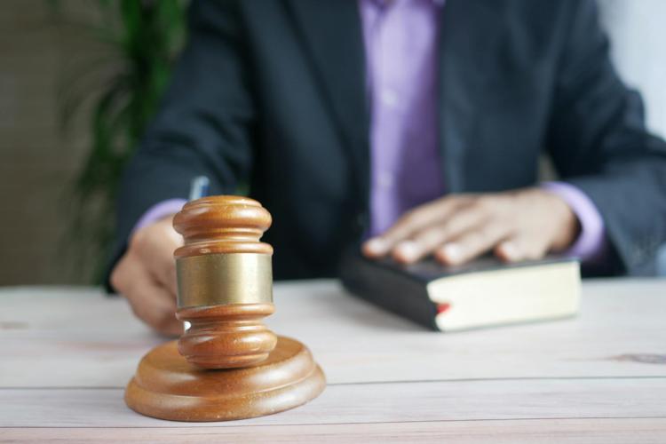 Person holding a brown gavel