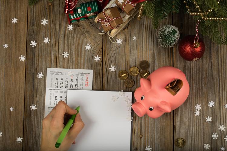 Blank sheet of paper and pink piggy bank on a New Year's background.