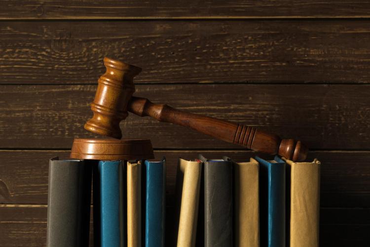 Gavel with books on a wooden desk