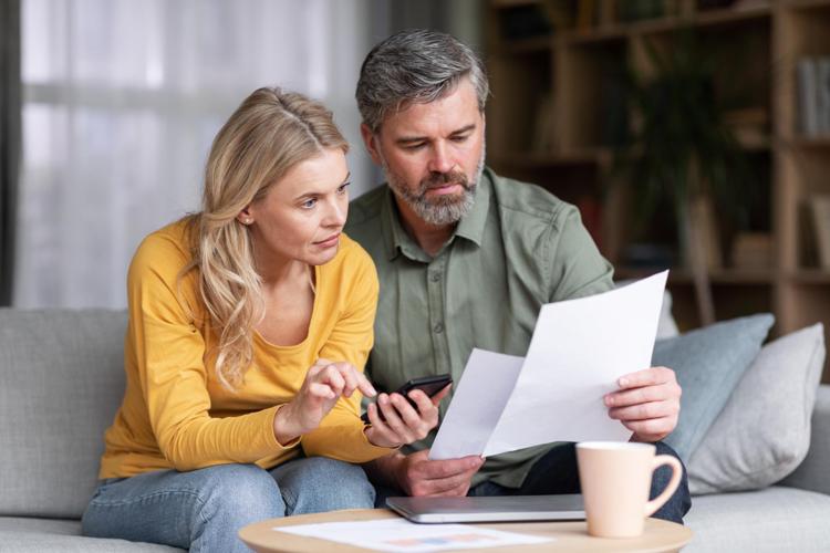 Couple will and estate planning using papers and a calculator