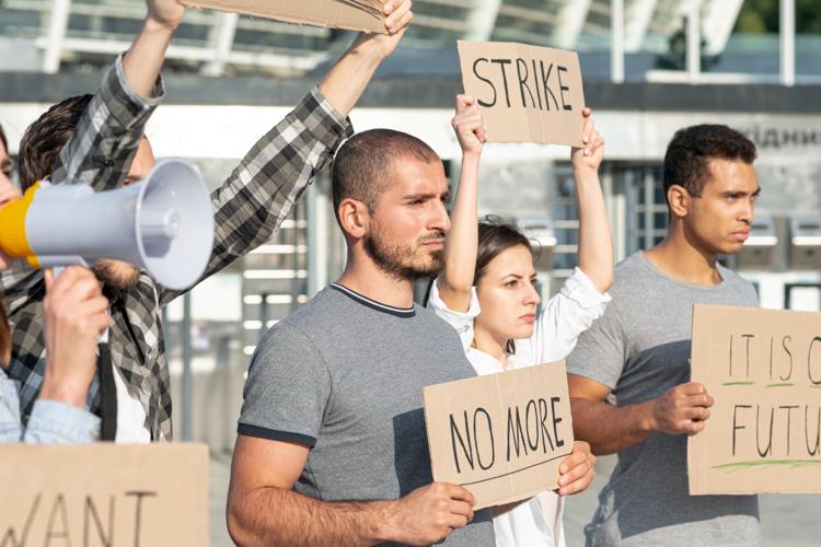 Striking workers holding signs