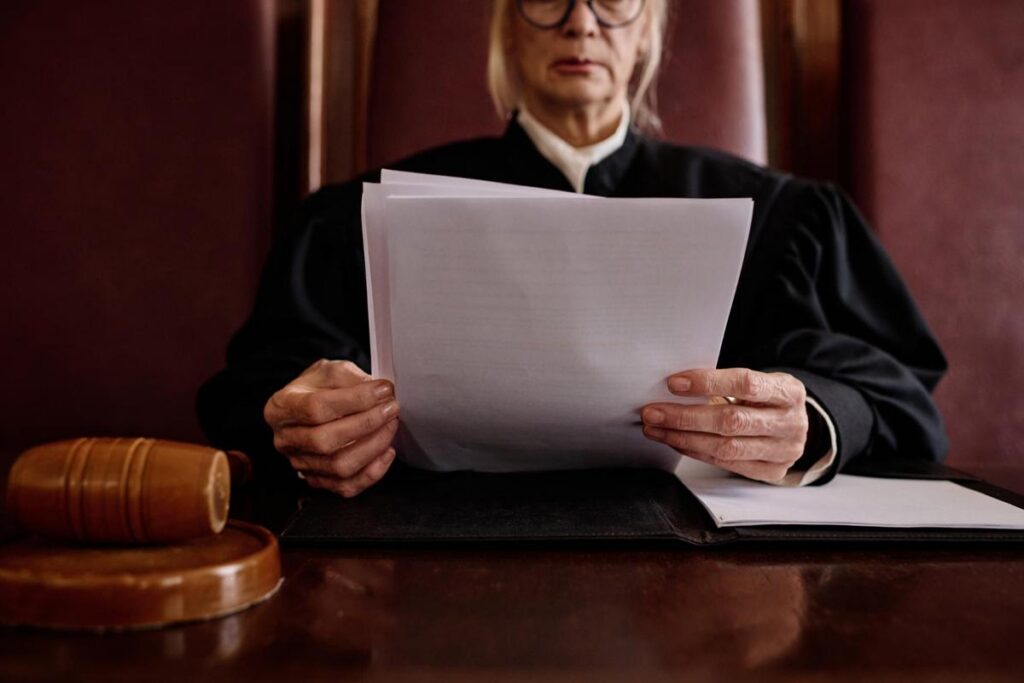 Closeup of a judge in a courtroom holding papers
